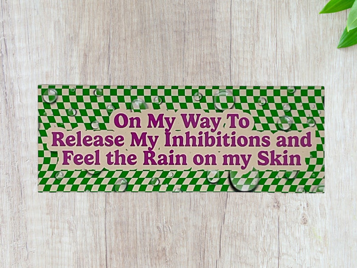 Green and cream checkerboard bumper sticker with pink text.